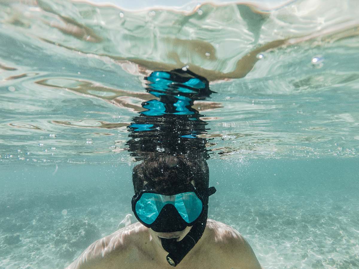 water underwater photography of person diving honolulu